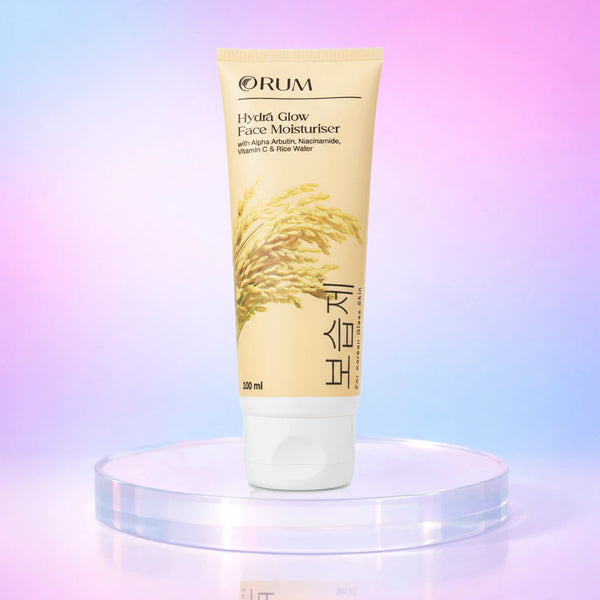 Tube of ORUM Hydrá Glow Face Moisturiser standing on a stand against a soft gradient background