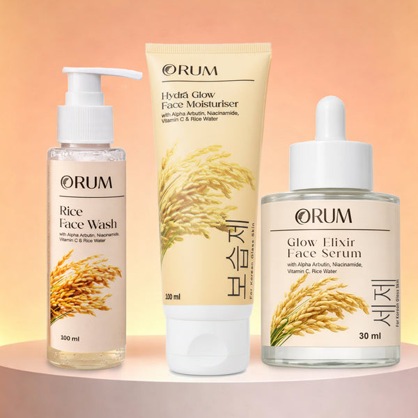 Three ORUM skincare products – Rice Water Moisturizer, Face Wash, and Serum – on a peach background